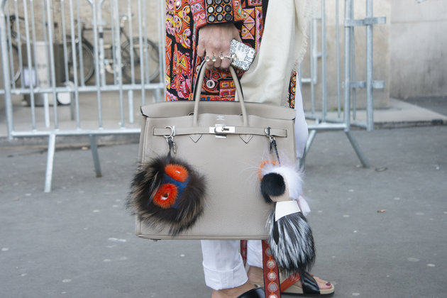 PARIS, FRANCE - MARCH 05: Art director at Kabuki Elini Halimi wears Barbara Bui coat, Hermes bag, Celine shoes, and Fendi pom poms on day 3 of Paris Collections: Women on March 05, 2015 in Paris, France. (Photo by Kirstin Sinclair/Getty Images)