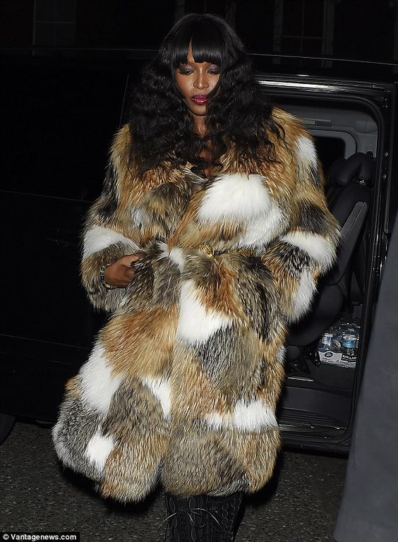 At her 45 with a statement fur coat