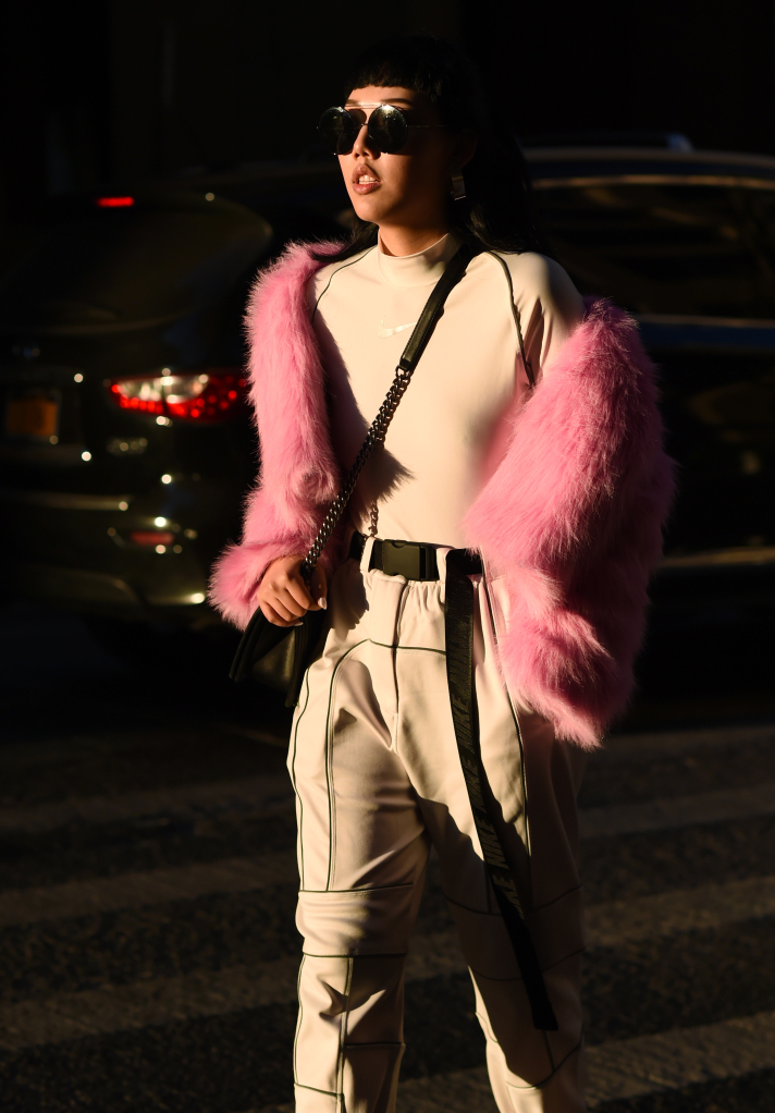  Michelle Song is seen wearing a pink fur jacket and Nike shirt outside the Tanaka show during New York Fashion Week: Men's Fall/Winter 2019 on February 04, 2019 in New York City.